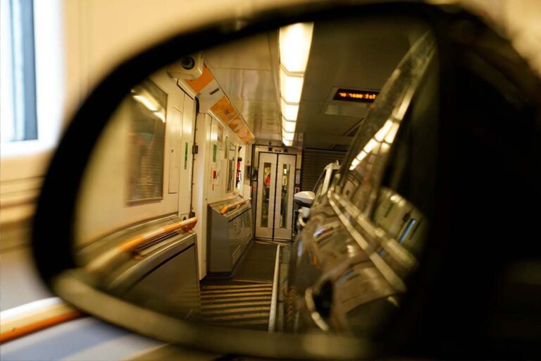 The interior of the Shuttle carriage visible through the side mirror.